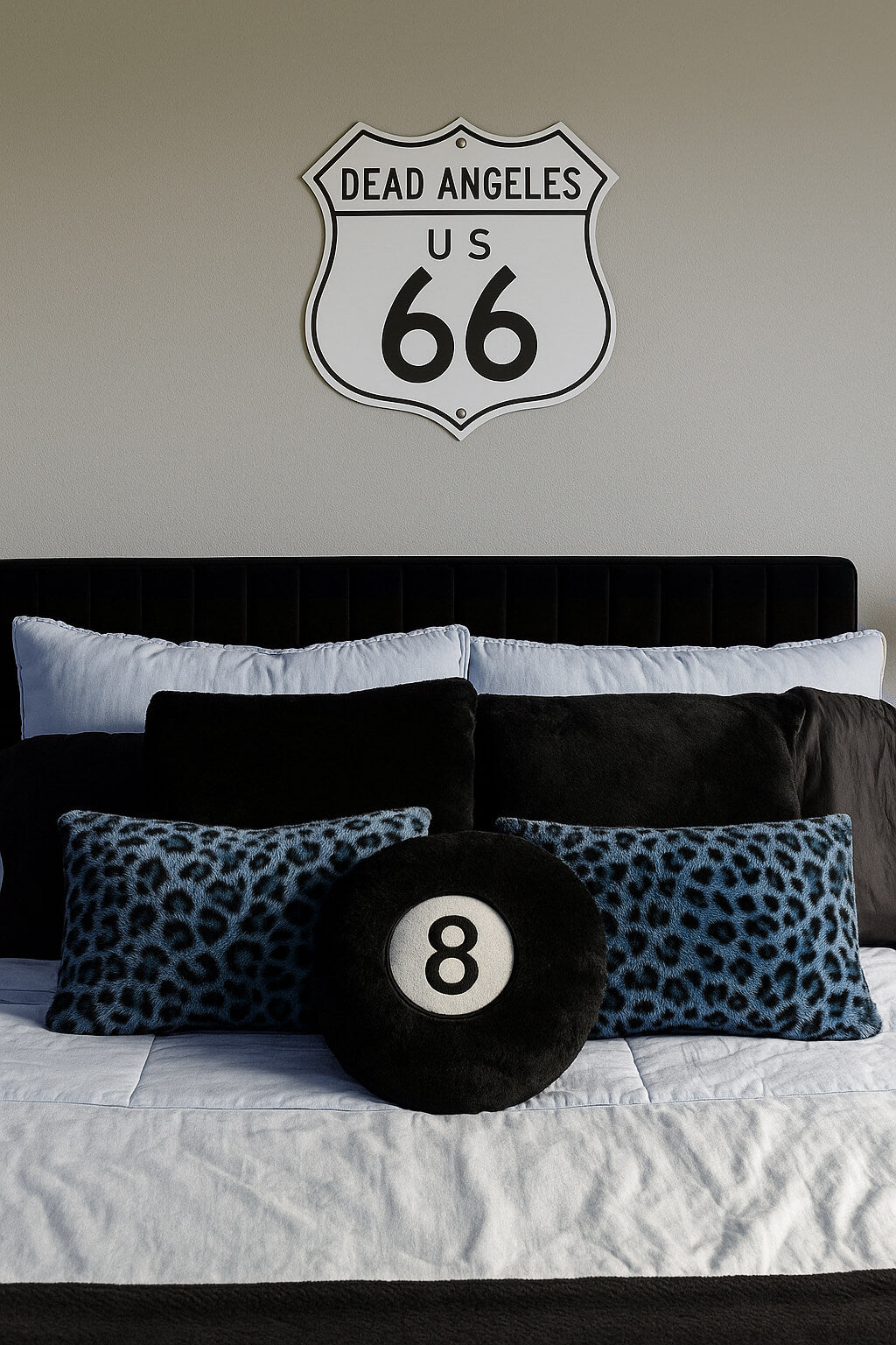 Front  view of dead angeles route 66 metal sign lying flat on white surface